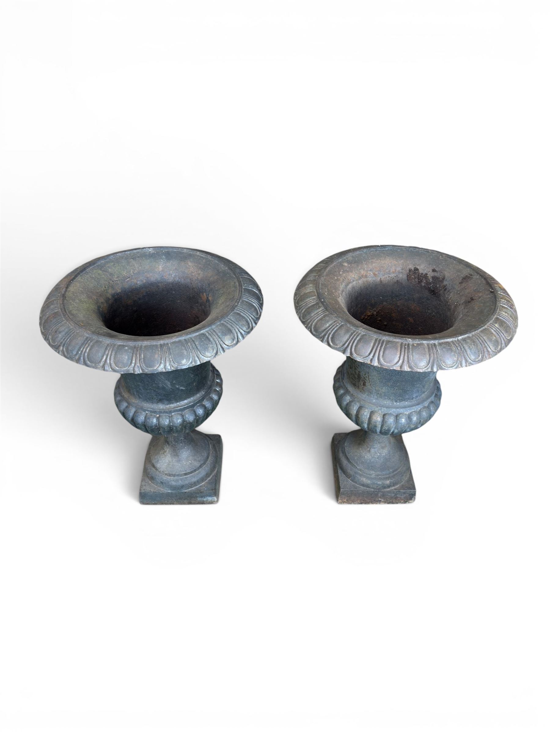 Pair of Victorian design heavy cast iron garden urns, black painted, egg and dart rim on waisted column