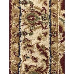 Contemporary Dunelm 'Legacy' ground rug, the field decorated with symmetrical scrolling foliate and floral motifs, bordered by an ivory band with repeating floral designs interspersed with leafy branches, inner guard stripe with fine linear patterning
