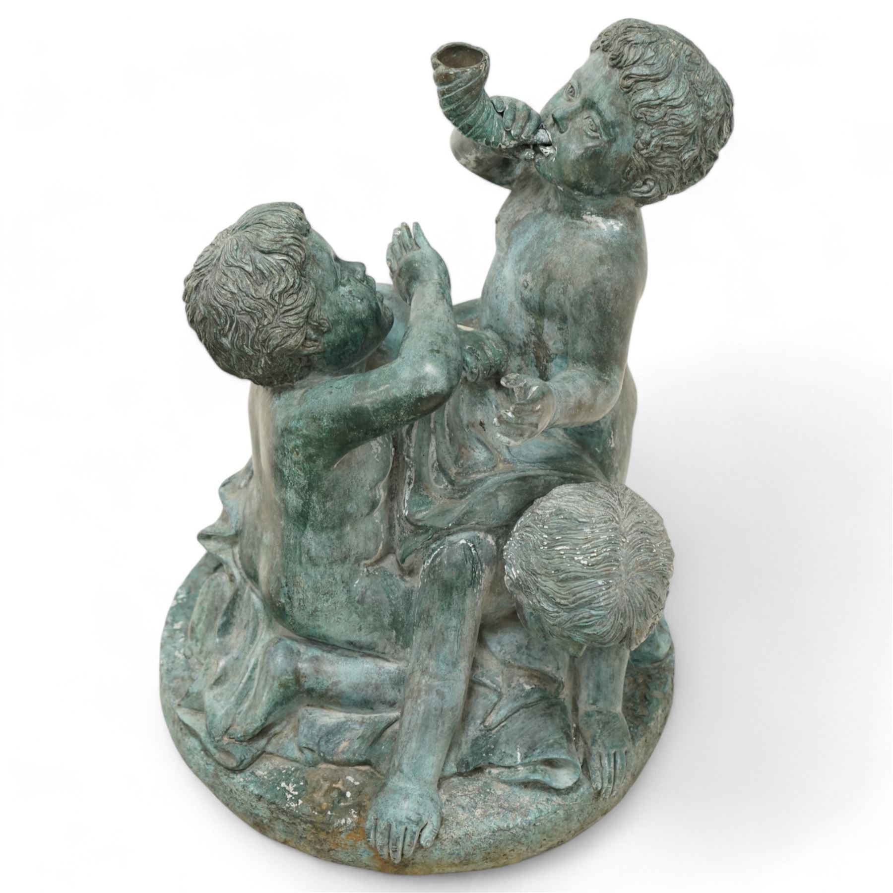 Cast bronze garden water fountain in the form of three Putti on circular naturalistic base, stamped 'Leonardo Rossi'  