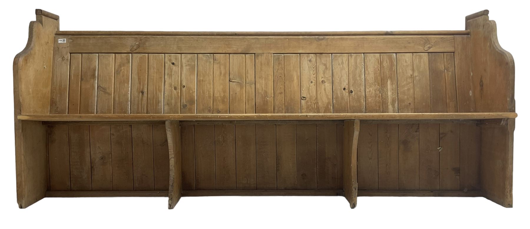 Early 20th century pine church pew, vertical plank back over rectangular seat, flanked by shaped end supports, with bible rest to back