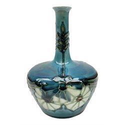 Minton Secessionist vase, with tube-lined stylised flower decoration, upon a blue ground, with printed mark to base 'Minton Ltd, No. 32', H13cm