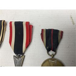 Two WW1 German medals - copy Cross of Honour with swords (combatants); Cross of Honour without swords (non-combatants); and two WW2 German medals - War Merit Medal; and War Merit Cross; all with ribbons (4)