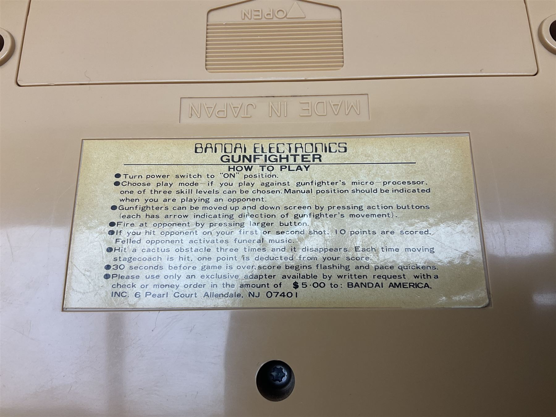 Three late 70s/early 80s handheld electronic games; Bandai Electronics Arcade ‘Gunfighter’ (1980), Grandstand ‘Invader From Space’ (1980), Palitoy ‘Merlin The Electronic Game Machine’ (1979) with game sheet and instruction booklet, all with original boxes (3) 