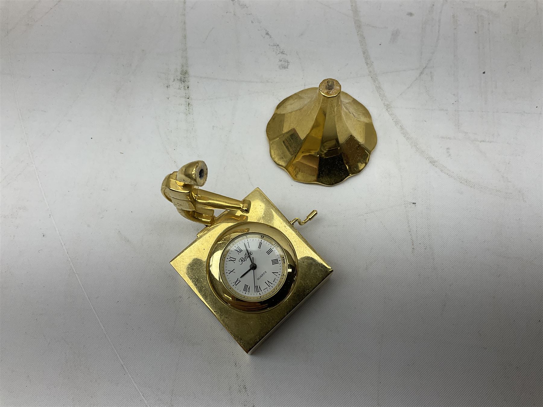 Collection of miniature clocks, predominantly with quartz movements, to include example modelled as an armchair, Edinburgh crystal glass example, clock modelled as a flower, sewing machine etc