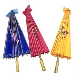 Three parasols, with flower decoration