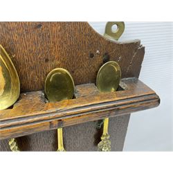 George III oak spoon rack and candle box, the rectangular backplate with shaped  pediment and two six aperture spoon racks, above a candlebox with hinged cover, with various brass spoons and a pair of brass candle snuffers, H56.5cm, W35cm, D14cm 