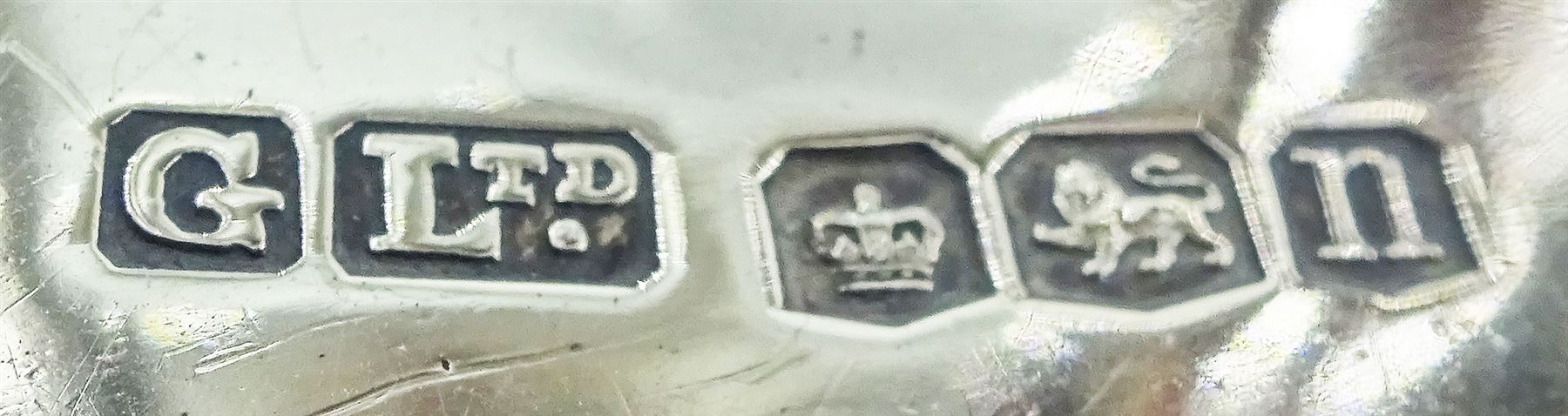 1930's silver model of an American boy scout, in full uniform, with one foot raised upon rocky modelled ground, hallmarked Gladwin Ltd, Sheffield 1930, upon an ebonised circular base, overall H31cm 