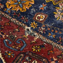 Turkish Anatolian wool rug, central stepped medallion on dark blue lozenge field, red spandrels with stylised hooked motifs, ochre border decorated with repeating geometric motifs and guard stripes