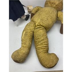 Mid-20th century woodwool filled teddy bear; and porcelain doll dressed as a WW2 evacuee