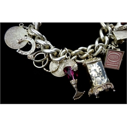  Silver charm bracelet including money box and clock, mostly stamped    