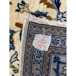 Persian Kashan ivory ground rug, the field decorated with stylised plant motifs and interlacing leafy branches, scrolling border decorated with further plant motifs, floral design guard bands  