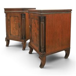  Pair of Regency mahogany bedside cabinets, rectangular top above a central cupboard door with flame mahogany veneer, flanked by spirally turned column uprights, raised on shaped supports