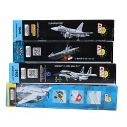 Four Cobi Bricks Armed Forces and Historical Collection model sets, comprising 1:144 scale no. 4852 U-Boot U-52 (Type VIIB), 1:48 scale no. 5900 Boeing F-15EX Eagle II, 1:48 scale no. 5848 Eurofighter and no. 5711 Junkers JU 52/3M, all in sealed boxes