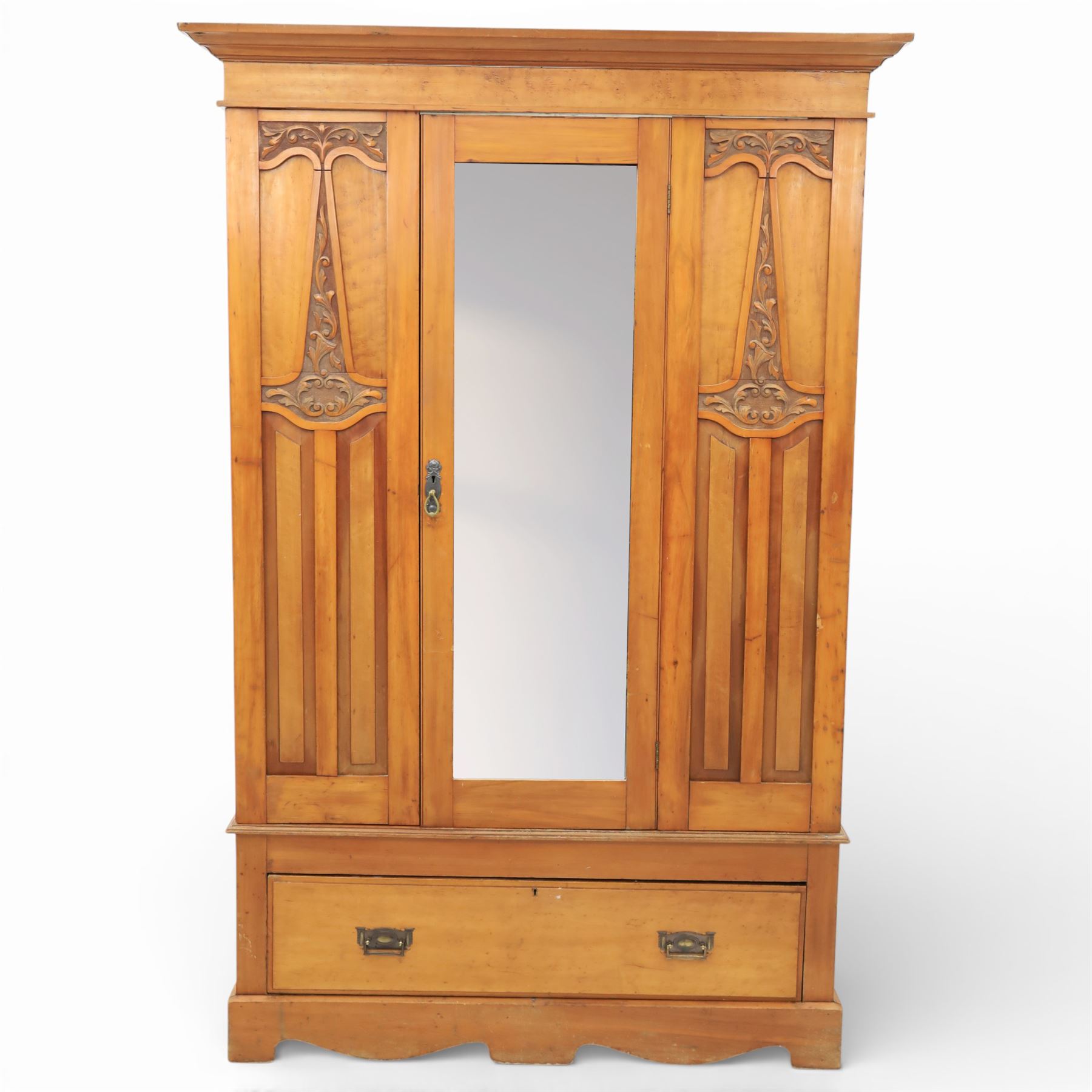 Early 20th century Art Nouveau walnut wardrobe, rectangular top over with single central mirrored panel door, the outer sides carved with sinuous foliate decoration and stylised stem motifs above recessed panels, single long drawer below with brass drop handles, on moulded plinth