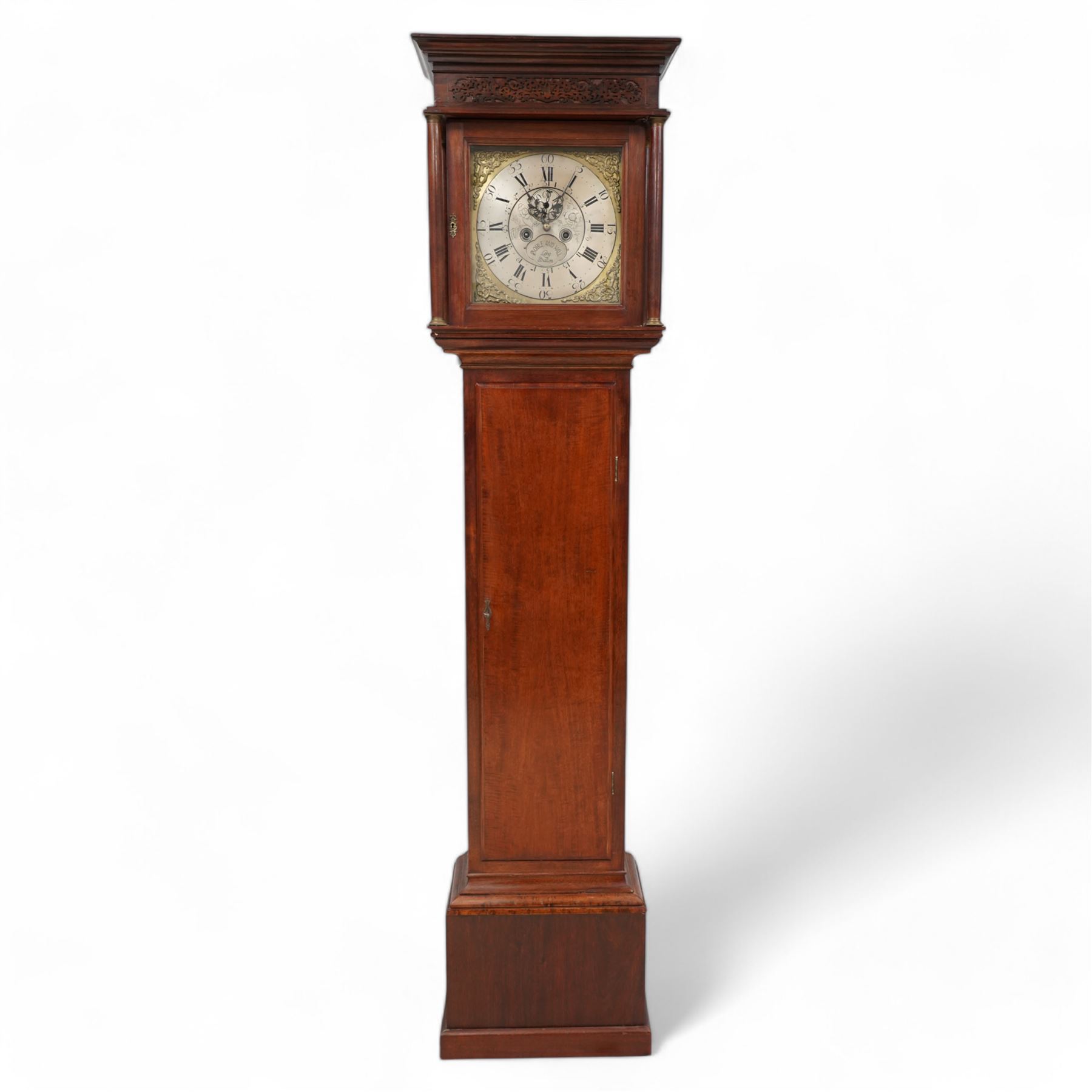 Mahogany - 8-day longcase clock, with a flat pediment and blind fret frieze beneath, square hood door with detached freestanding pilasters, trunk with a flat topped door on a short plinth with applied skirting,  square brass dial with cast spandrels and a silvered chapter with Roman numerals and five-minute Arabic's, engraved dial centre with seconds dial and silvered cartouche inscribed 