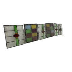 Six leaded stained glass window panes, largest measuring - 46cm x 41cm