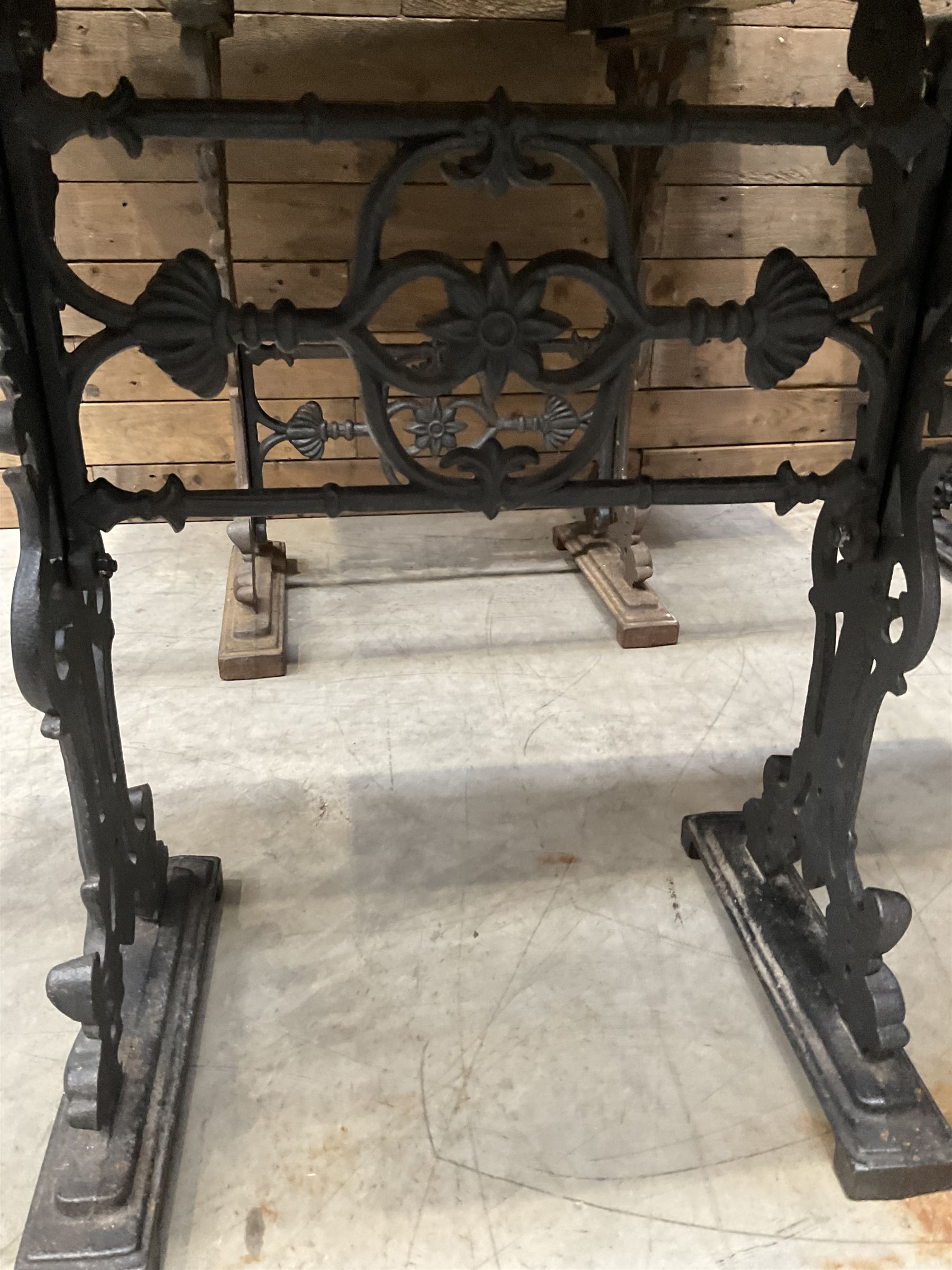 Four cast iron pub or bar tables with rectangular tops