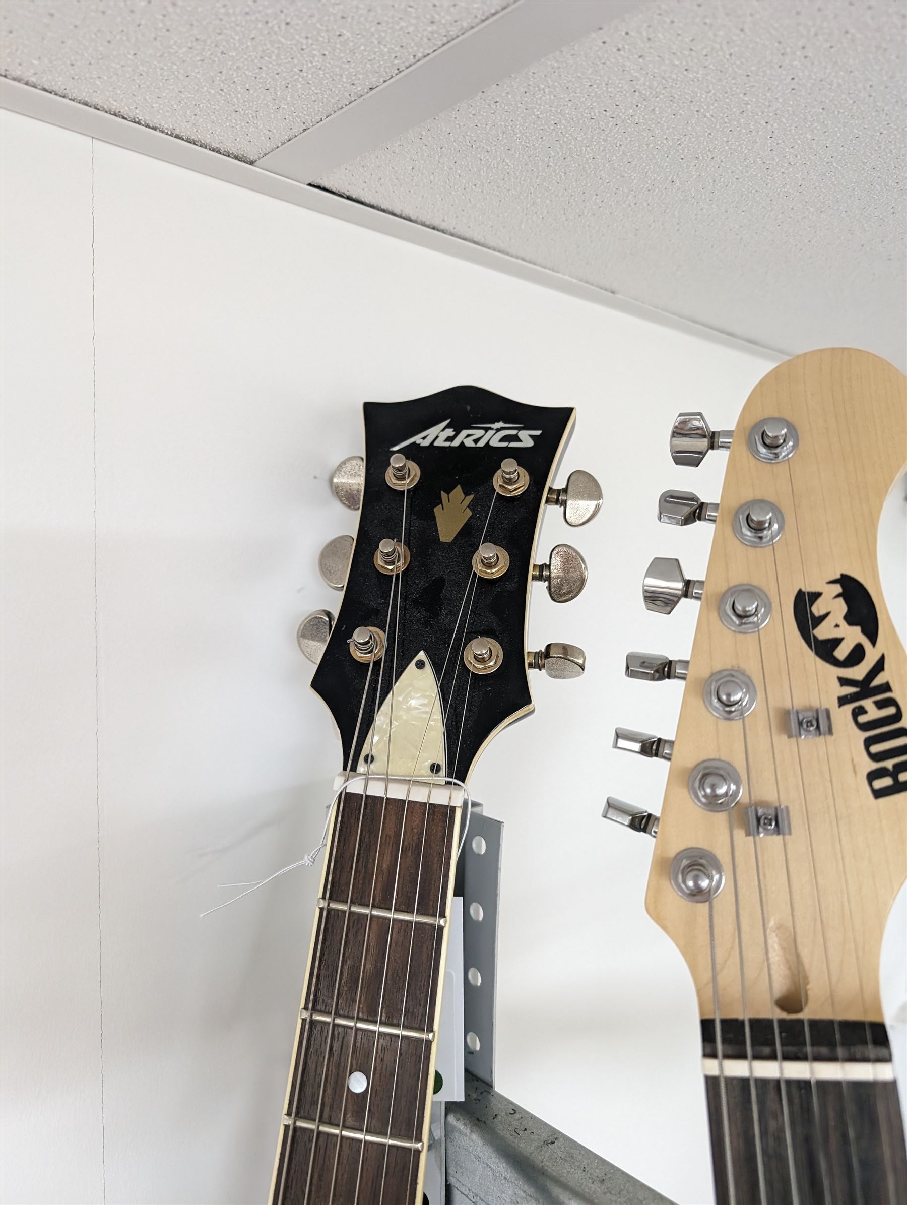 Rock Jam six string electric guitar, together with a Rock Jam amplifier and an Atrics guitar