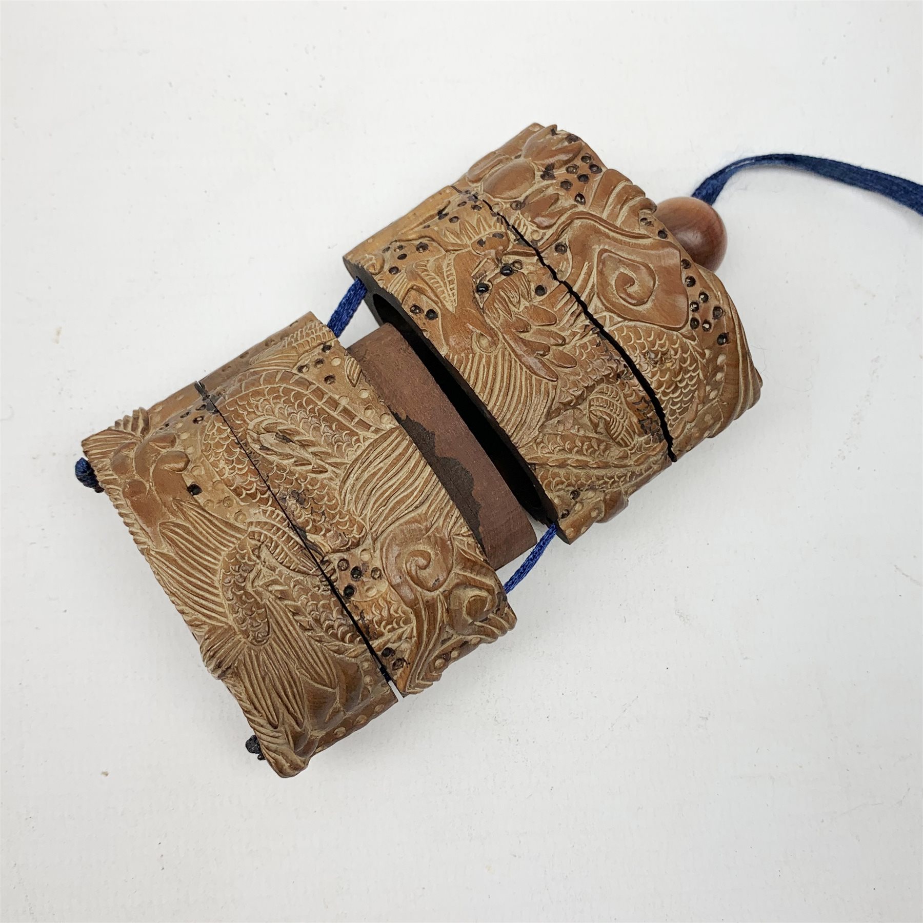 Japanese Meiji wooden four case inro, carved with dragons, with dragon netsuke and ojime bead, H8cm  
