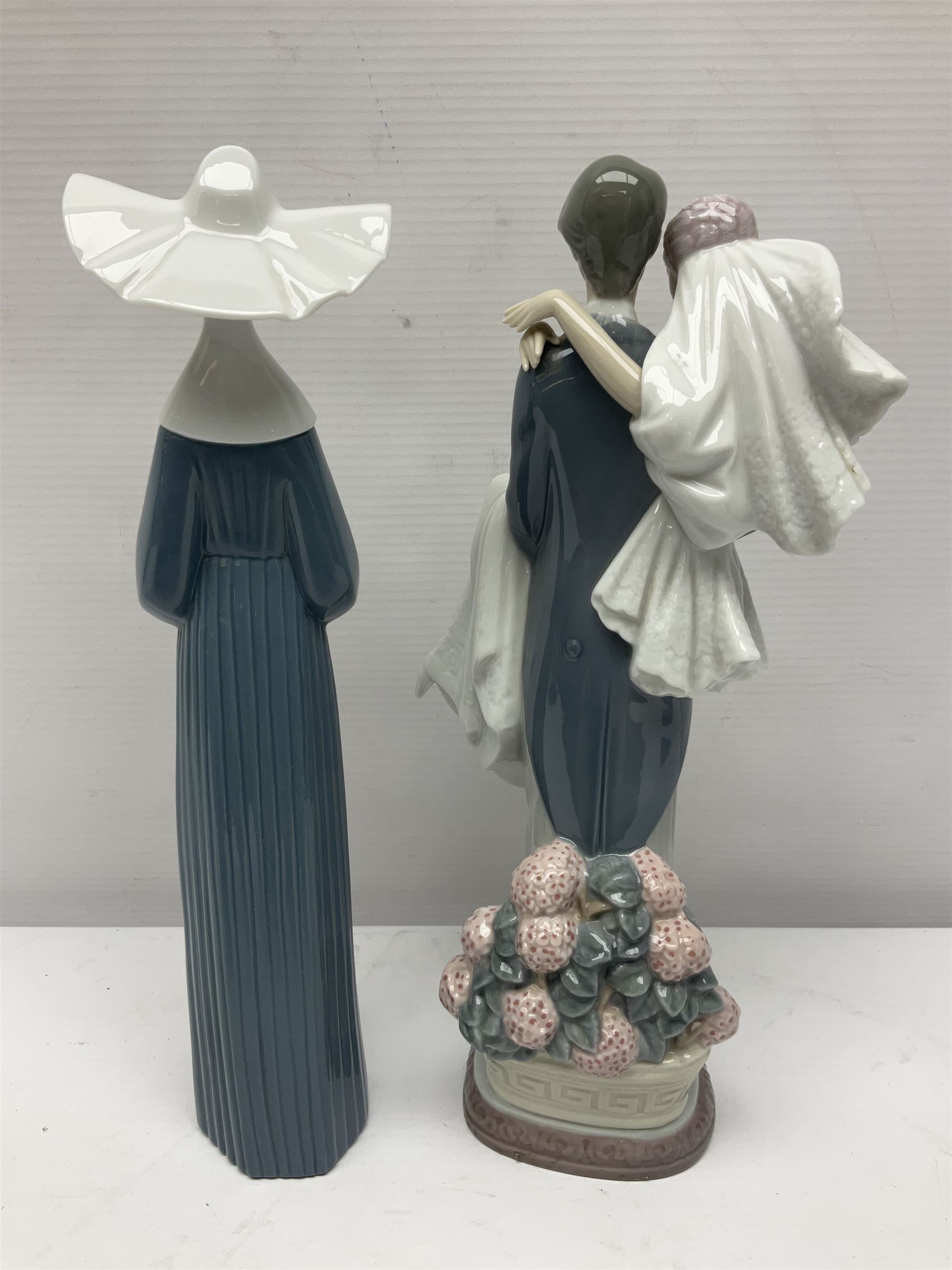 Two Lladro figures, Over the Threshold no 5282 and Prayful Moment no 5500 together with five Nao figures