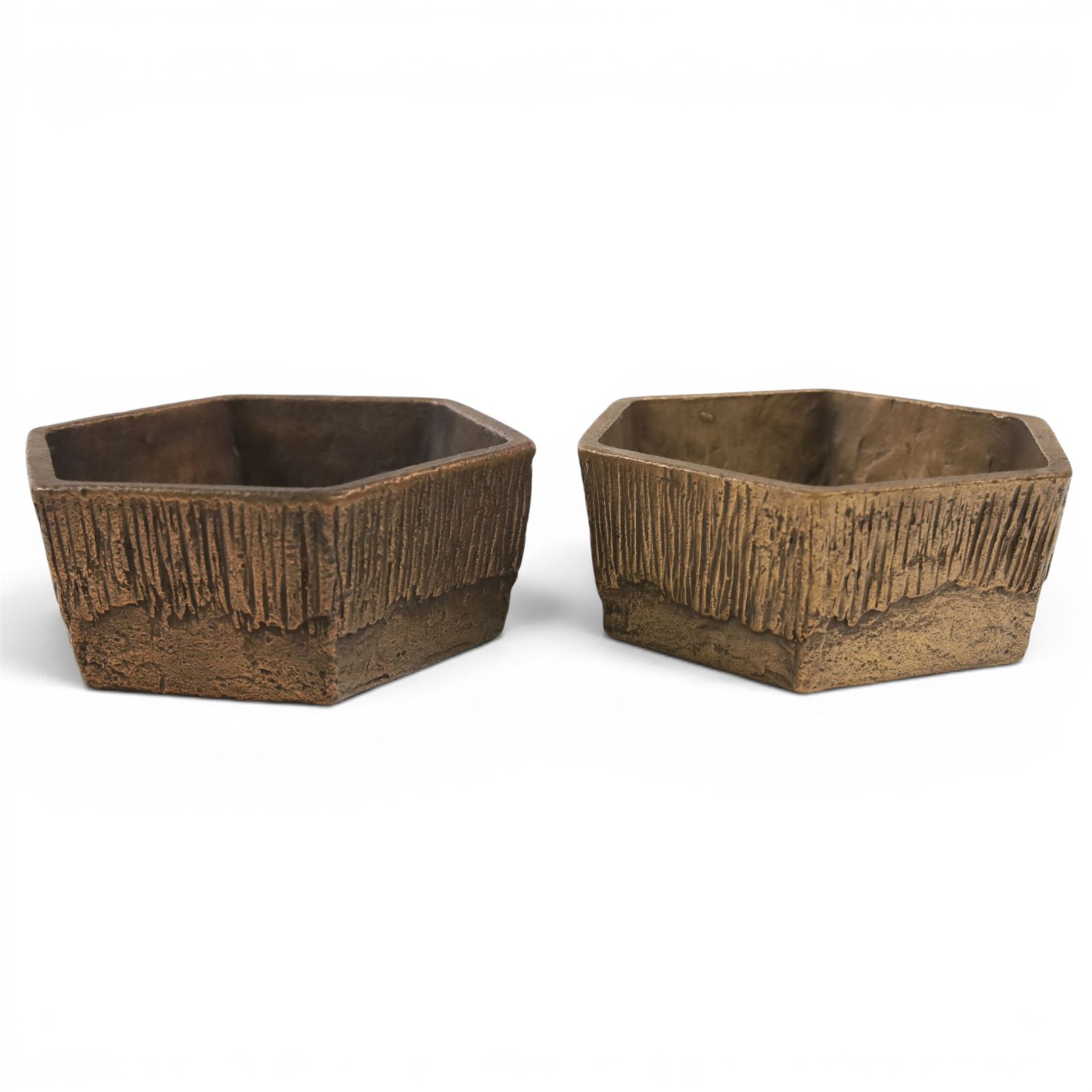 Pair of brutalist candle holders, together with similar wall sconce