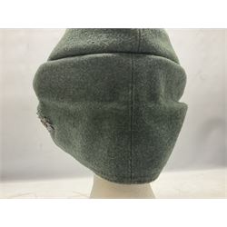 WW2 German Army M43 field cap with triangular cloth eagle and roundel badge and metal edelweiss badge for mountain troops; faintly stamped '5 VMF(?)'