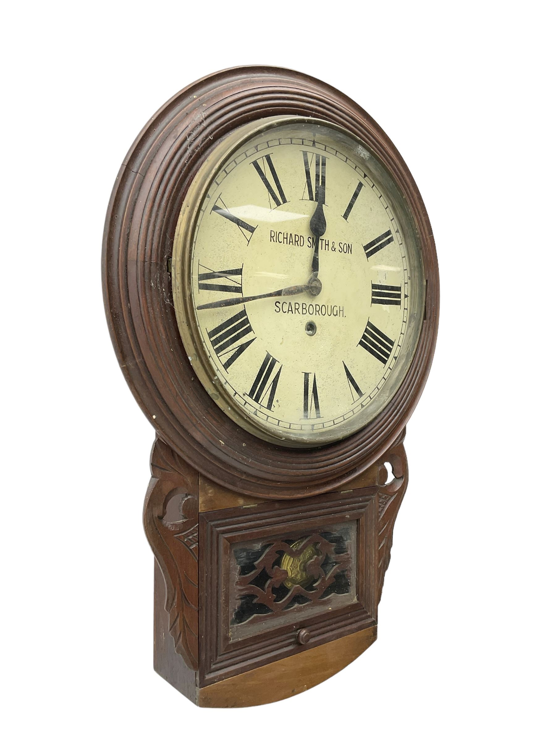 Richard Smith & Son, Scarborough - drop dial 8-day mahogany wall clock, with a turned wooden bezel, carved ear pieces and pendulum box with a glazed door and open carved fretwork,12