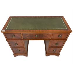 Music system in the form of a Georgian design twin pedestal desk, the reed moulded rectangular top hinges to reveal Garrard turntable with Dynatron Amplifier, fitted with speakers enclosed by two doors disguised as drawers, on bracket feet