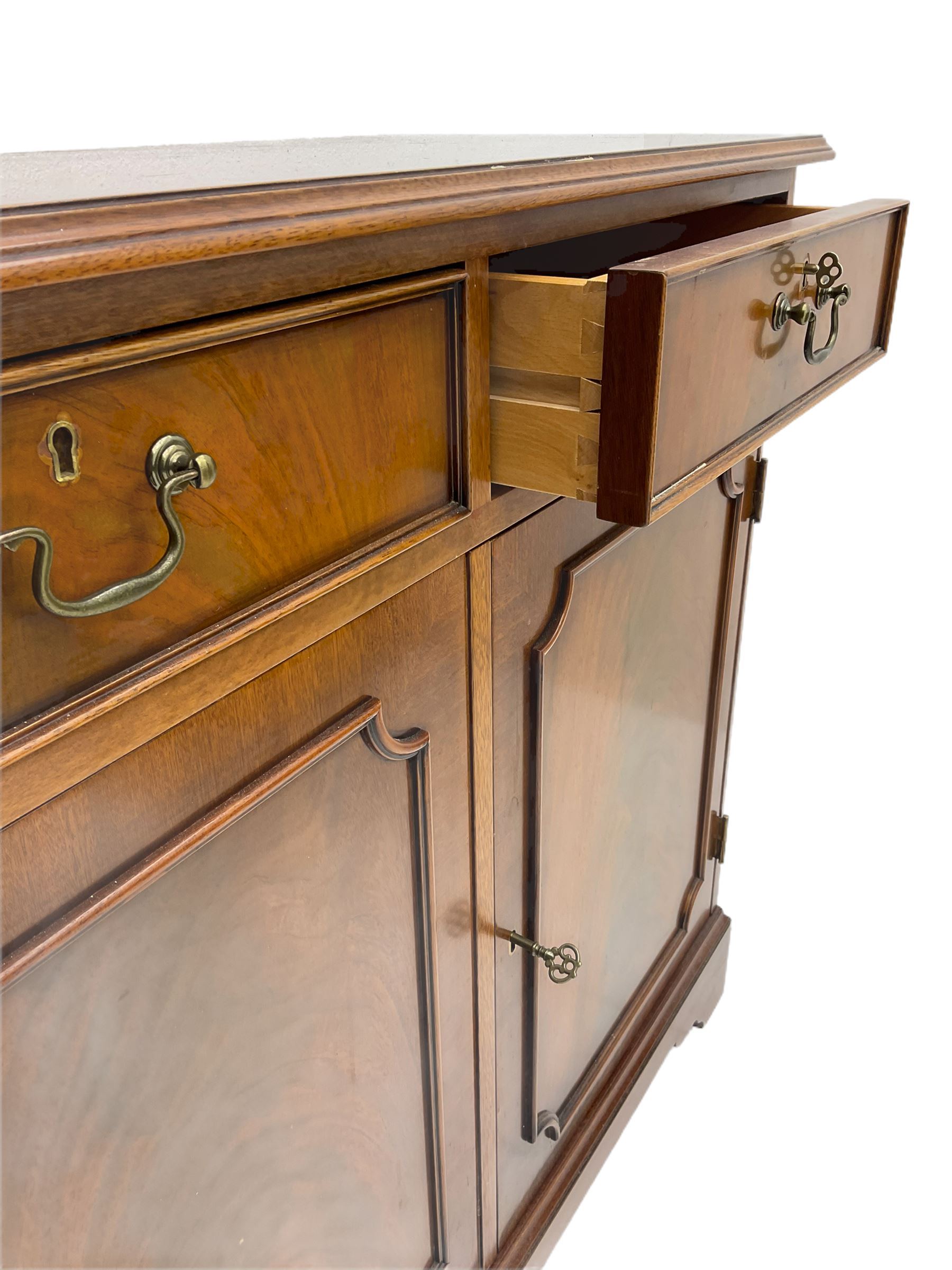 Reproduction mahogany side cabinet, moulded rectangular top over two drawers and double cupboard, bracket feet