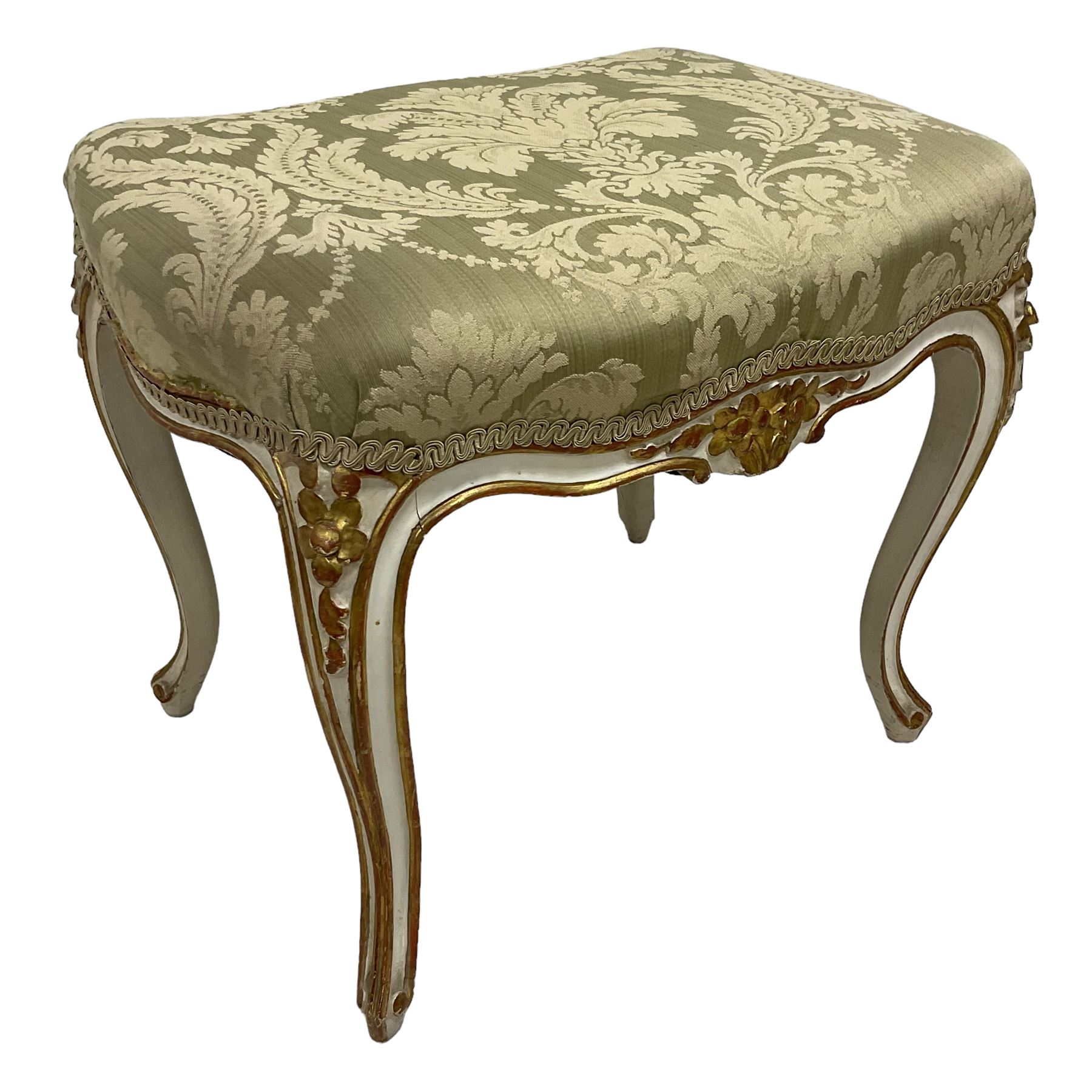 20th century French design parcel gilt and painted dressing table stool, upholstered in sage green damask fabric, shaped form on floral carved cabriole supports, with matching cushion 
