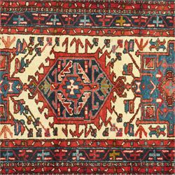 Caucasian Shirvan hand-knotted runner, ivory field decorated with a vertical sequence of bold hexagonal and lozenge medallions, each enclosing stylized geometric motifs, flanked by angular floral latch-hook devices, field dominated by madder red  and ivory with subsidiary colours of indigo, brown, and turquoise, with fringe ends   