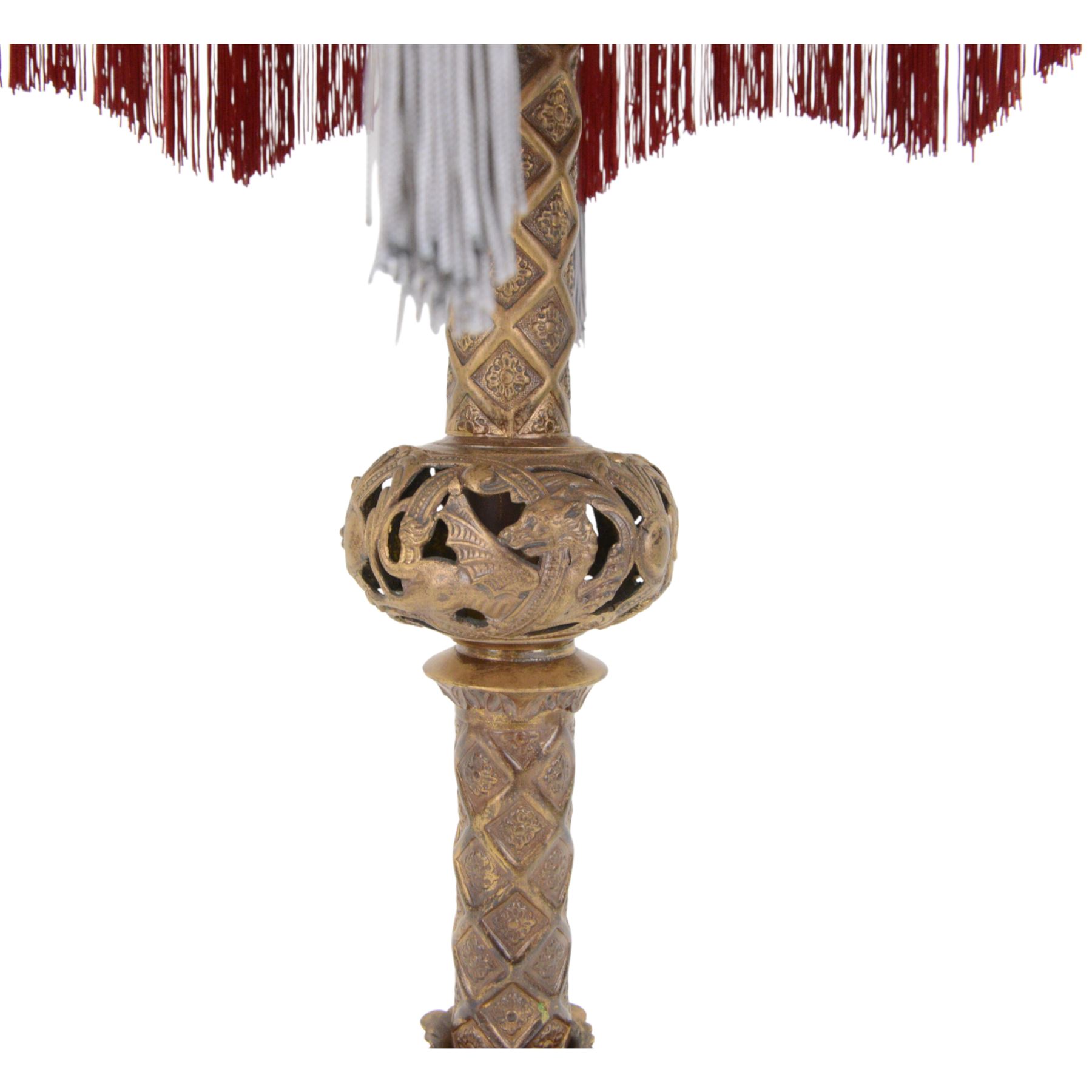 Gilt table lamp, three lion paw feet on a triangular base with column central support decorated with floral motifs, with octagonal shade, H85cm 