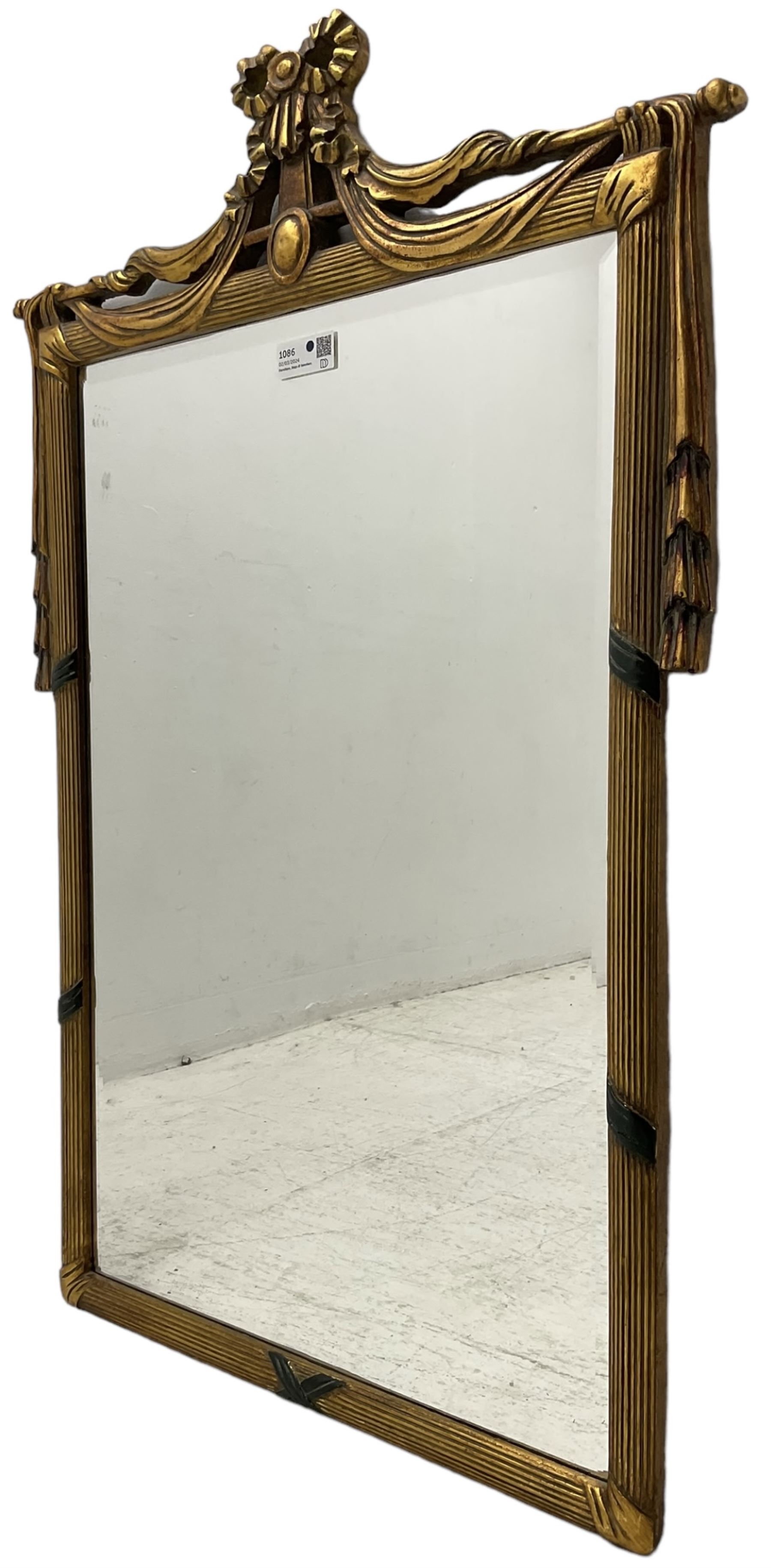 Regency design gilt framed wall mirror, ribbon pediment over hanging linen swags, bevelled mirror plate enclosed by reed moulded frame 