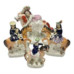 Staffordshire figure of a child riding a spaniel, together with pair of Staffordshire figures of children on horseback and a similar smaller example , child on spanial H22cm