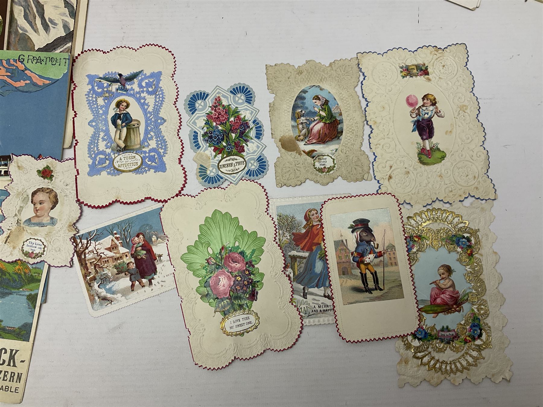 Early 20th century ephemera, to include signed photographs of Charles Boyer and Walter Pidgeon etc, a printed letter from Winston Churchill, two albums and a quantity of transfer books of Players and similar cigarette cards, including Boy Scout and Girl Guide Patrol Signs and Emblems and RAF Badges, a collection of greetings cards and postcards, a photograph album containing black and white photographs of Caius College Cambridge and guides and pamphlets on travelling Switzerland and the UK