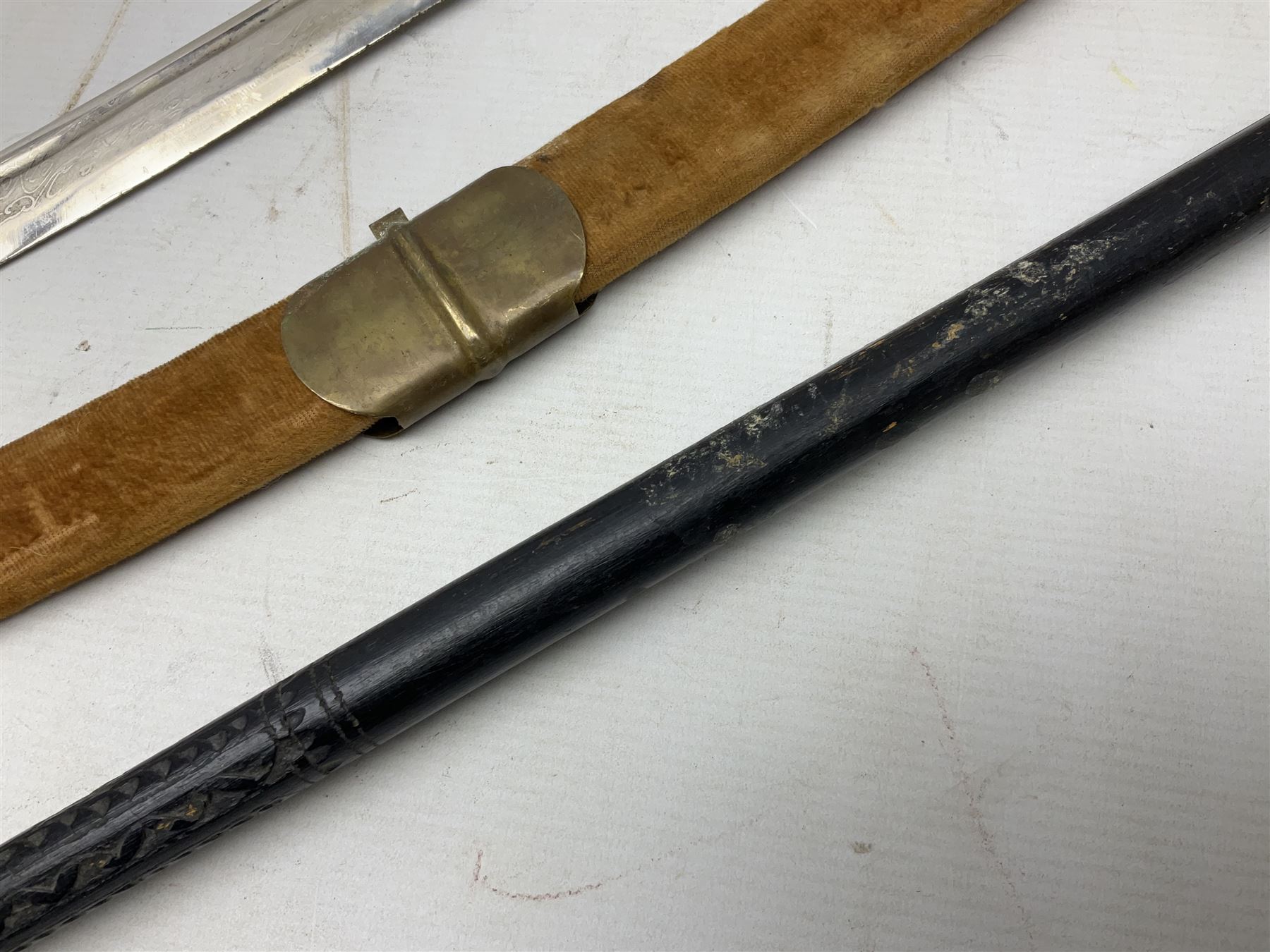 Early 20th century Indian ebonised sword stick, the 59.5cm blade with punched decoration and horn grip L94cm overall; and a reproduction Indian tulwar with scabbard (2)