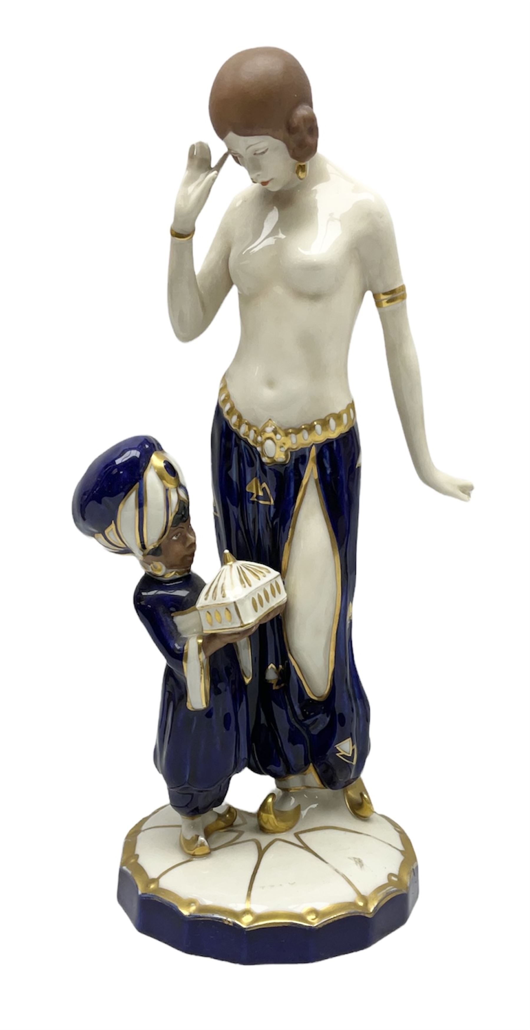 Royal Dux Art Deco figure group of Turkish dancing girl with a young boy beside her holding a casket, decorated with gilding, raised upon scalloped edge plinth base, with applied pink triangle and impressed 2948 beneath