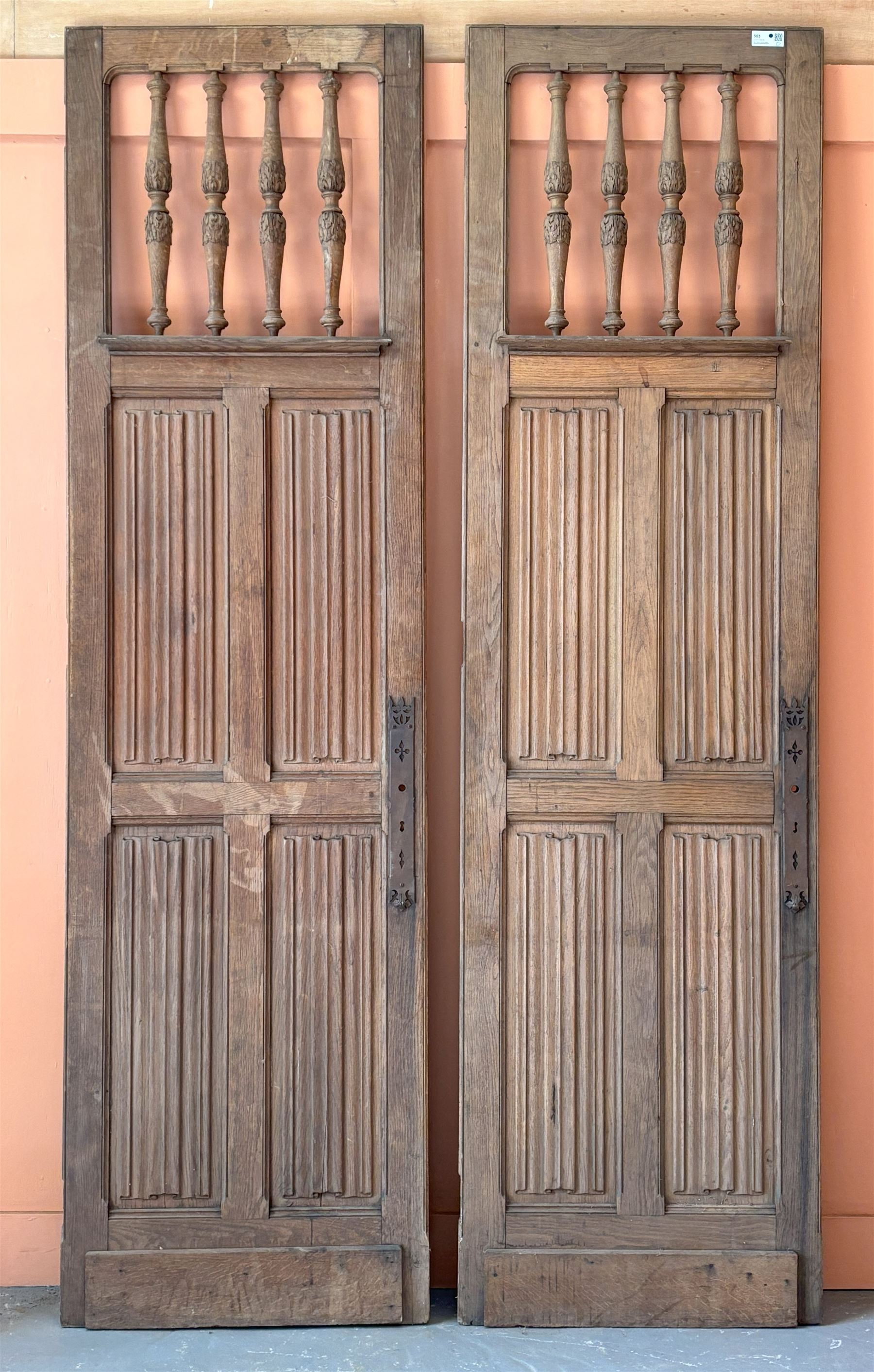 Decorative pair of French oak room screen doors, late 19th century, each having acanthus carved and turned spindles above four fielded linen fold panels. H258cm W72cm - COLLECTION BY APPOINTMENT FROM: The White House, Thirsk Road, Easingwold, York, YO61 3NF - CALL 01723 507111 TO ARRANGE