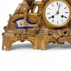 French-late 19th century gilt and spelter mantle clock, highly decorative case with two Sevres style porcelain panels to the front and surmounted with three figures of children playing musical instruments, white enamel dial with Roman numerals and steel moon hands, two train countwheel strike movement, striking the hours and half hours on a bell. With key and pendulum.    
