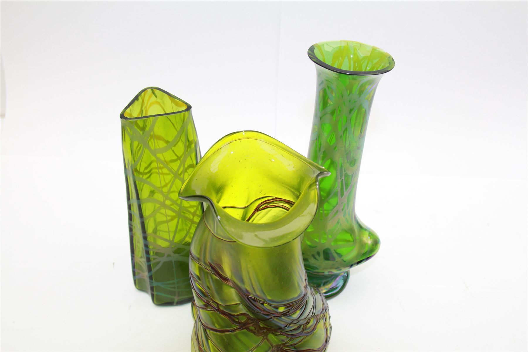 Three Austrian Art Nouveau green iridescent glass vases, to include two Pallme-Konig examples and a Kralik example, each with threaded vein decoration, tallest H25cm (3)