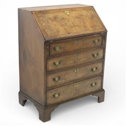 19th century walnut bureau of small proportions, the sloping fall enclosing a fitted inter...