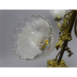  Early 20th century gilt metal four light electrolier, the pressed glass shades issuing on scrolling foliate cast arms above a cut glass acorn shaped glass shade, H74cm x W57cm approx  