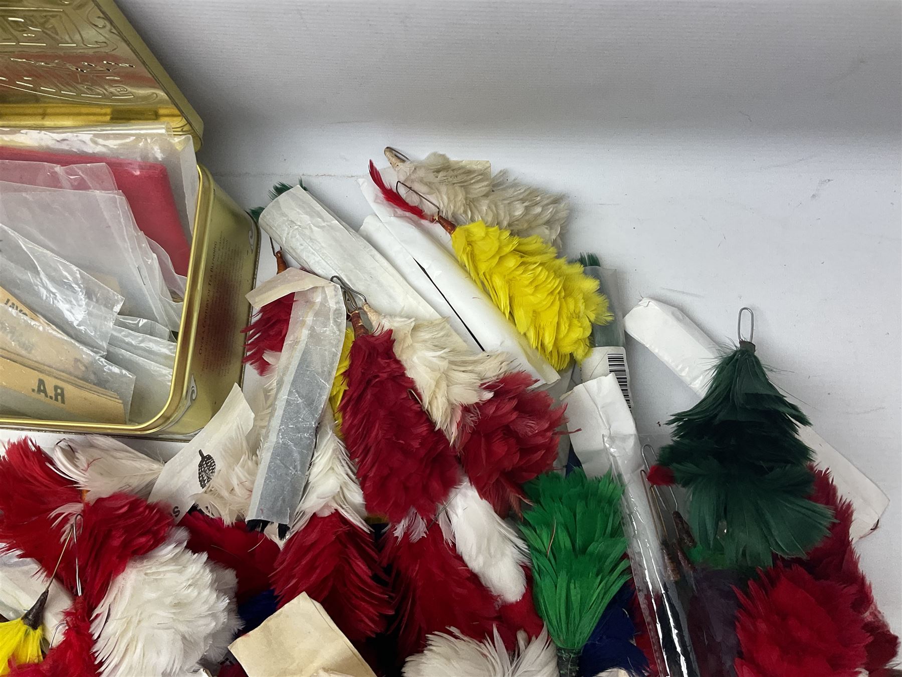 Quantity of military horse hair plumes and feather hackles, cloth stripes and regimental titles etc