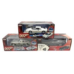  Three RCERTL Joyride James Bond 1:18th scale die-cast model cars - 1965 Aston Martin DB5 from Goldfinger, Lotus Esprit from The Spy Who Loved Me and Aston Martin DB5 from Casino Royale, all boxed (3)
