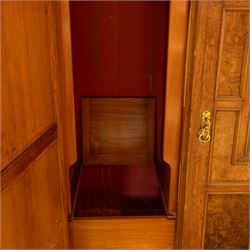 Late Victorian oak and burr oak three-section mirror wardrobe, central door with three carved panels with shell and acanthus decoration, fitted with four drawers and four tray drawers, linen sides with bevelled mirrored panel doors with hanging space, plinth base, and dental cornice