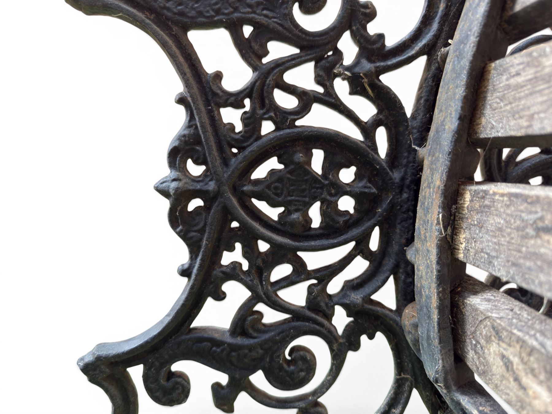 Victorian Andrew McLaren pattern cast iron bench, the ornate ends with detailed scrollwork, joined together with a cast iron seat and backrest frame supporting gently weathered oak slats, Victorian diamond stamp mark