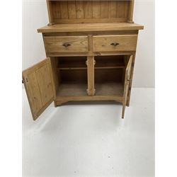 Pine dresser, two shelve plate rack, above two short drawers and two cupboard doors 