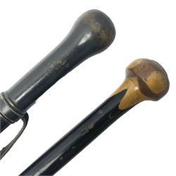 Two ebonised walking sticks, one with 'Leeds City Police' embossed top, tallest H92cm