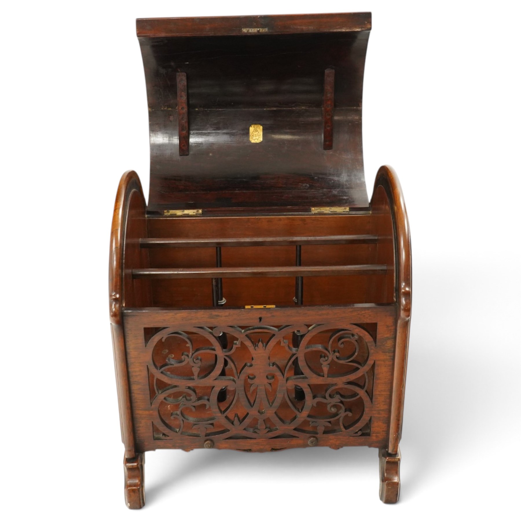 Victorian rosewood enclosed music Canterbury, the domed hinged cover enclosing a three-division interior, above a pierced scrolling foliate fretwork front panel, flanked by curved uprights and raised on scroll feet, hinged top applied with brass registration lozenge for 19 January 1860