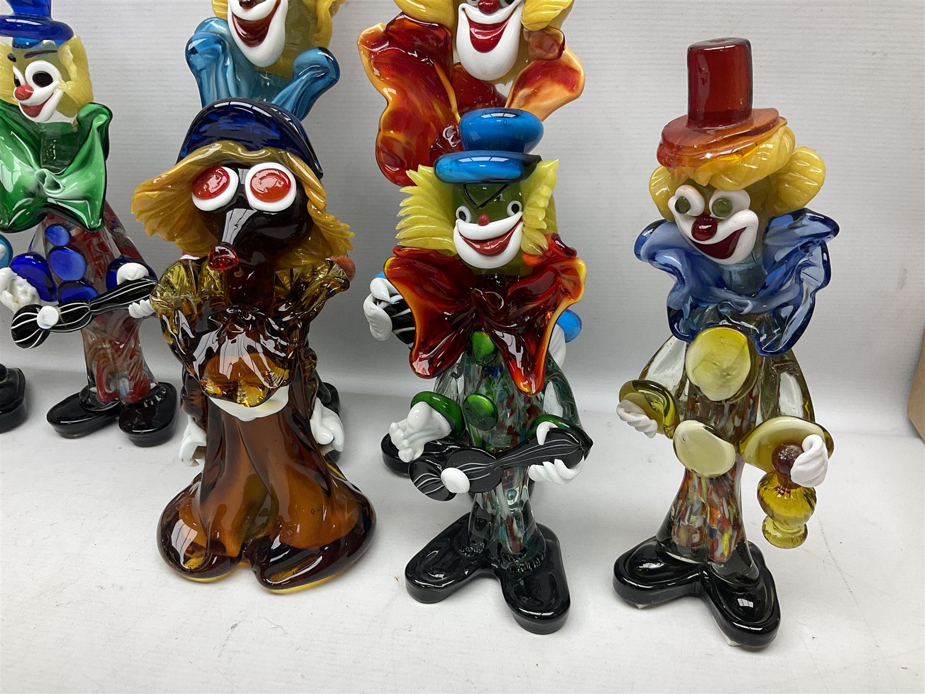 Large quantity of Murano glass clowns, to include larger examples, in two boxes